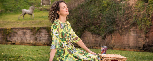 how to picnic perfectly - lady on picnic rug with hamper