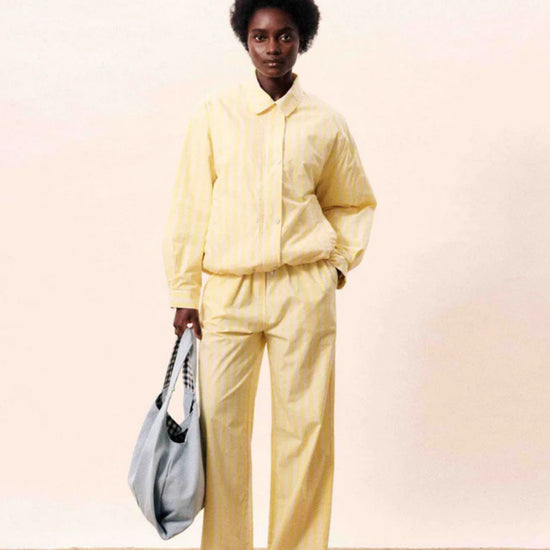 Butter yellow striped wide-leg trousers with a relaxed fit.