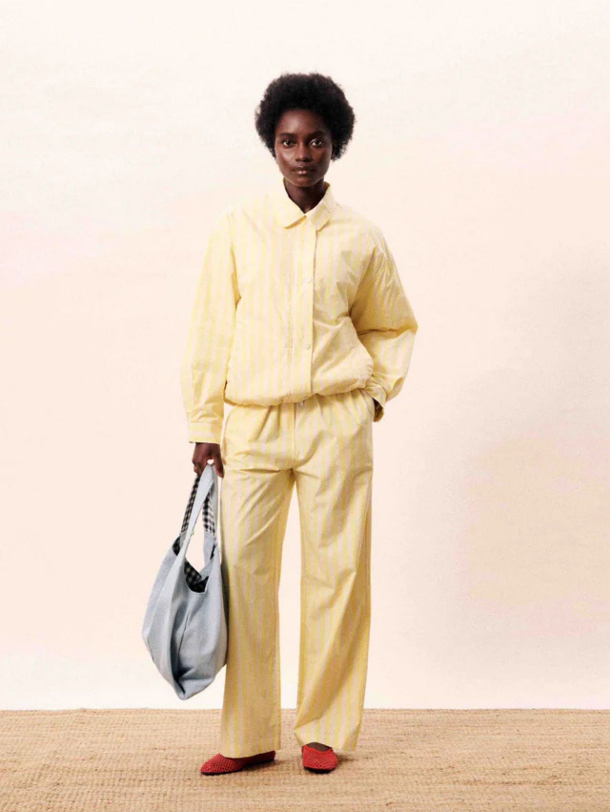 Butter yellow striped wide-leg trousers with a relaxed fit.