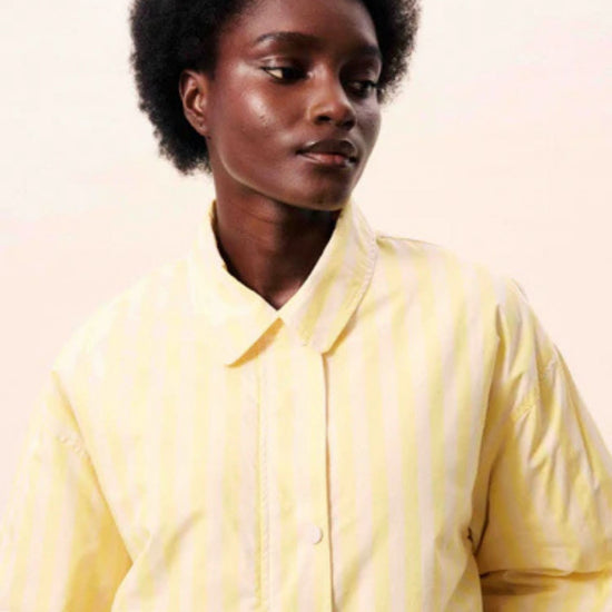 Butter yellow striped jacket with a relaxed fit, button and hidden zip front.