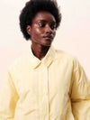 Butter yellow striped jacket with a relaxed fit, button and hidden zip front.