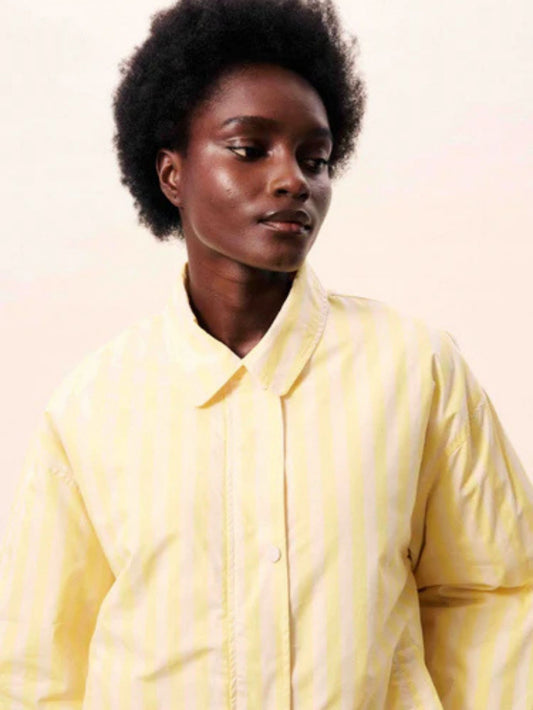 Butter yellow striped jacket with a relaxed fit, button and hidden zip front.