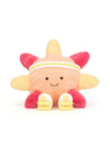 A plush toy shaped like a smiling sun or flower with a peach face, yellow petals, pink petals, and small white shoes, photographed on a clean white background.