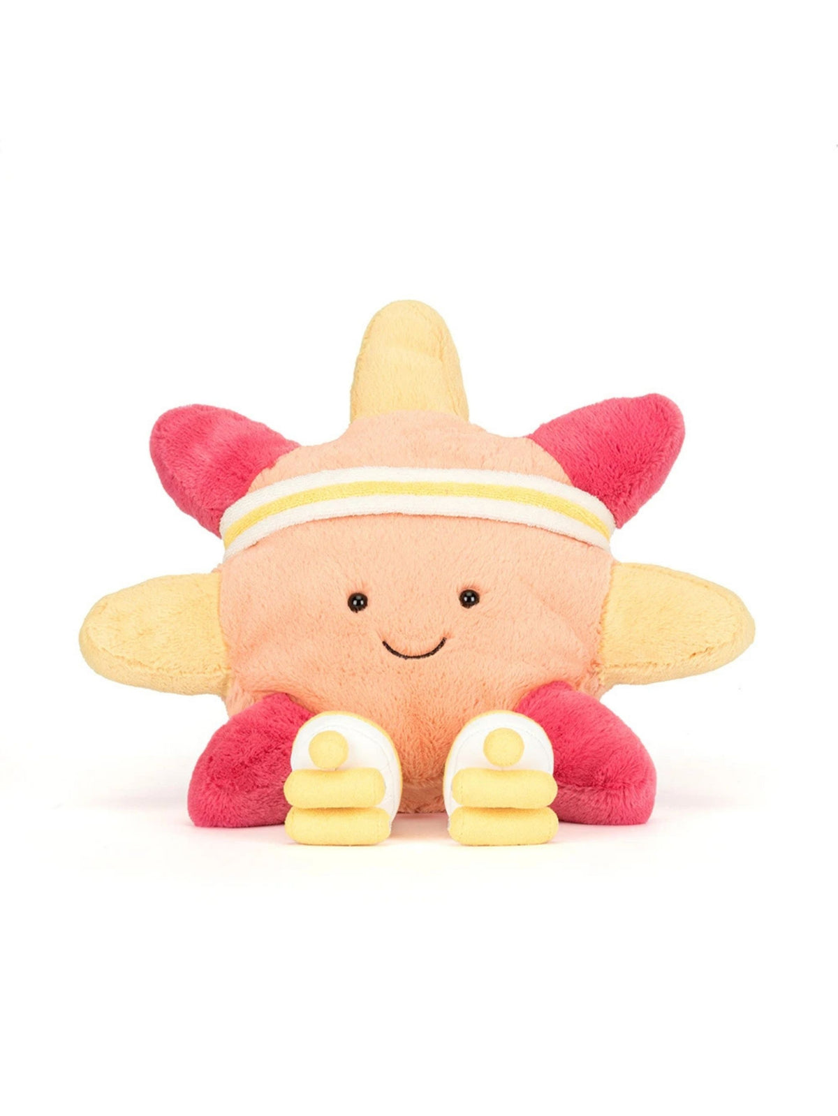 A plush toy shaped like a smiling sun or flower with a peach face, yellow petals, pink petals, and small white shoes, photographed on a clean white background.