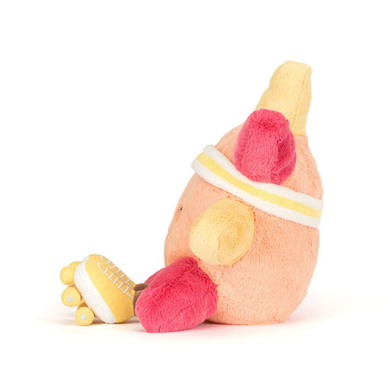 A plush toy shaped like a stylized peach-colored body with bright pink feet and yellow hands, wearing a white and yellow headband, photographed on a clean white background.