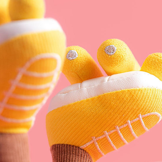 Yellow socks with white soles and decorative elements on a pink background