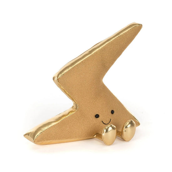 A small gold lightning-bolt-shaped plush toy with a smiling face and tiny feet, photographed on a clean white background.