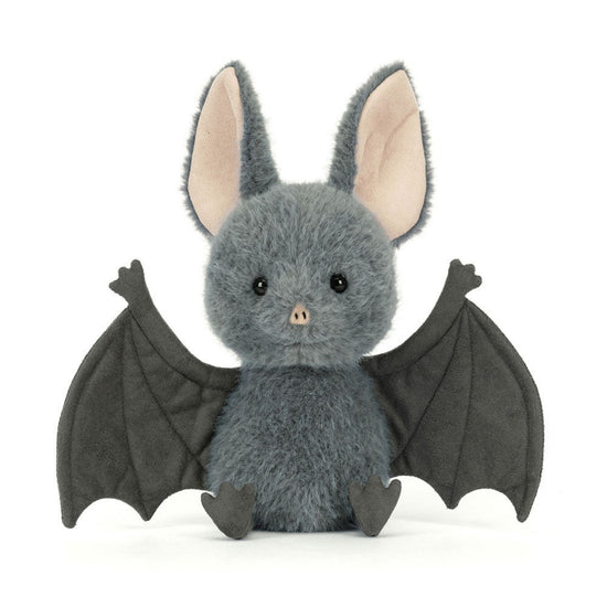 A plush toy bat in medium gray with large black wings, pink inner ears, and small black feet, sitting against a plain white background.