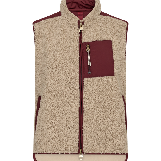 A sleeveless fleece vest in beige sherpa with contrasting burgundy panels on the chest pocket, zipper trim, and inner lining, shown against a plain white background.