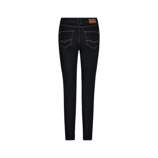 Rear view of dark wash skinny jeans with contrast tan stitching and a brown leather patch on the back waistband, shown against a plain white background.