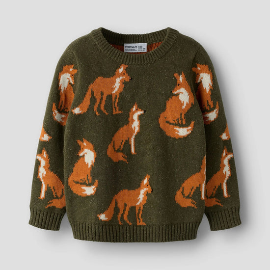 An olive green knit sweater featuring an all-over pattern of orange and white foxes, displayed against a neutral light gray background.