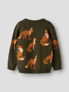 An olive green knit sweater featuring a pattern of orange and white foxes, shown from the back against a light gray background.