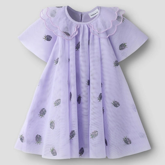 A light purple baby dress with a ruffled Peter Pan collar and scattered embroidered pineapples, shown against a neutral light gray background.
