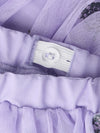Close-up of a lavender purple mesh garment with a white button closure and ruffled trim.
