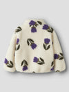 White fleece jacket with purple floral patterns on a light gray background