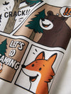 Close-up of a white T-shirt featuring a comic-style camping graphic with a brown bear, orange fox, tree, and text reading 'CRACK!!' and 'LET'S GO CAMPING'.