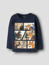 A navy blue long-sleeve t-shirt for kids, featuring a large cartoon comic-style graphic on the front with foxes, bears, trees, mountains, and text like 'A DAY IN THE WILDLIFE' and 'LET'S GO HIKING'.