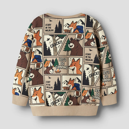 A children's long-sleeve sweatshirt with a beige base and a cartoon comic-panel print featuring foxes, bears, pine trees, and camping text, shown on a light gray background.
