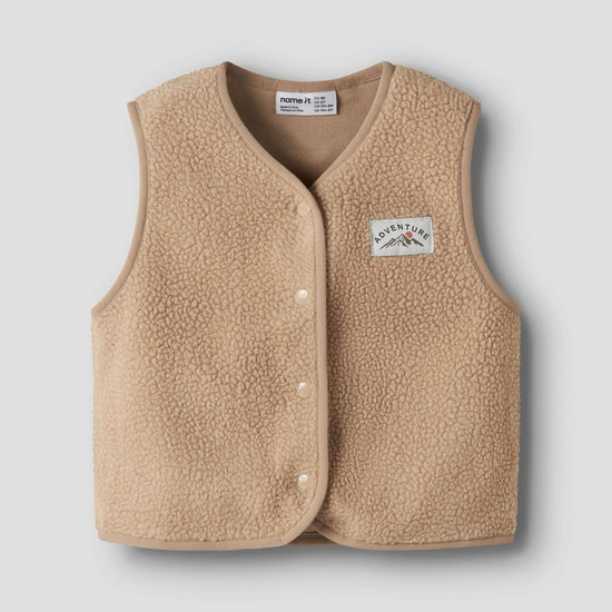 beige teddy vest on a grey background