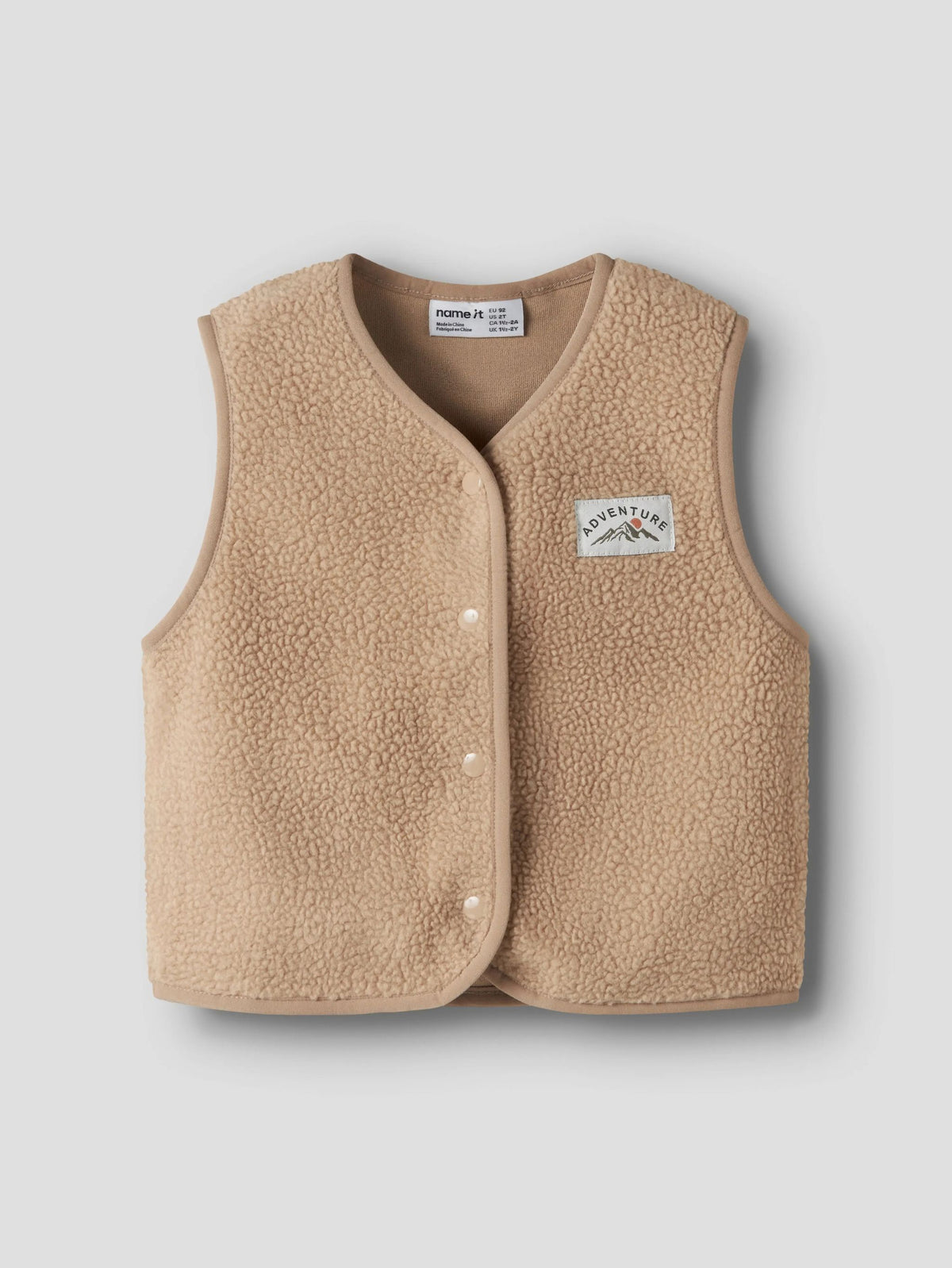 beige teddy vest on a grey background