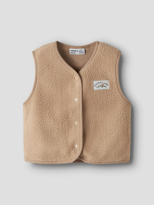 beige teddy vest on a grey background