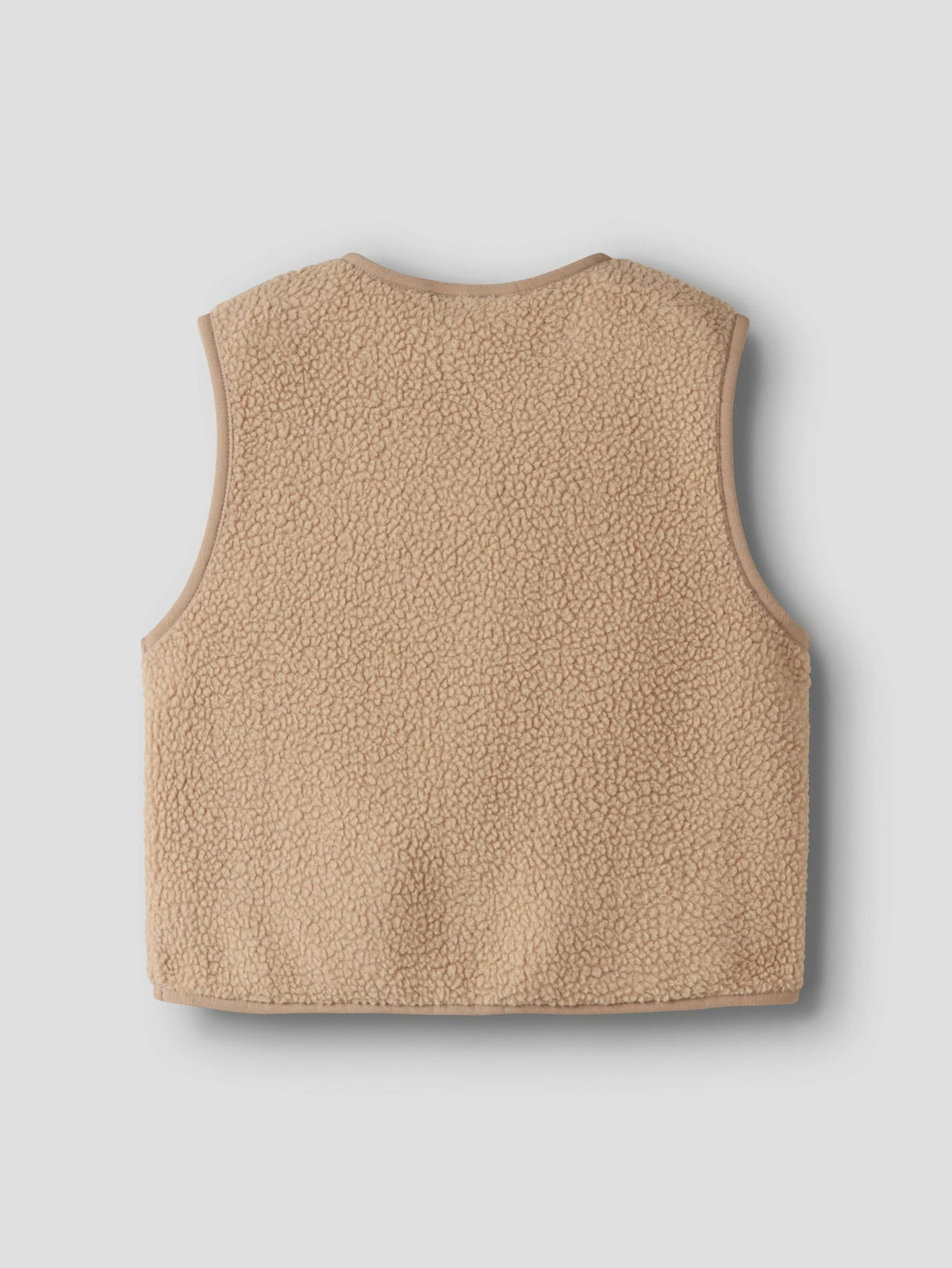 the back of a beige teddy vest on a grey background