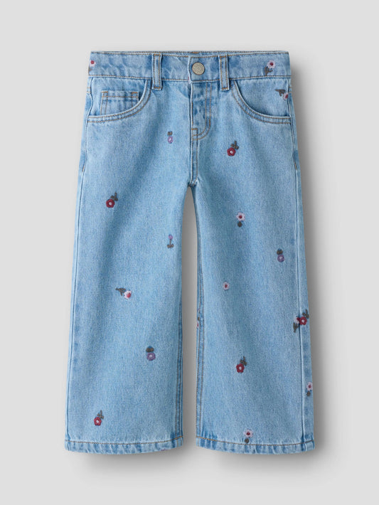 blue jeans with embroided flowers scattered over them