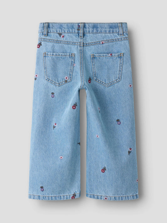 Light blue denim jeans with floral embroidery on a light gray background