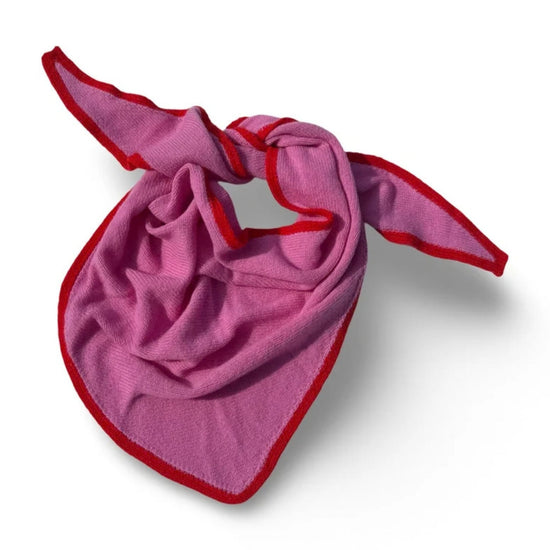 A folded Pink Triangular Scarf with red trim, arranged in a crossed pattern on a white background.