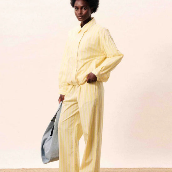 Butter yellow striped wide-leg trousers with a relaxed fit and lightweight tailored finish.