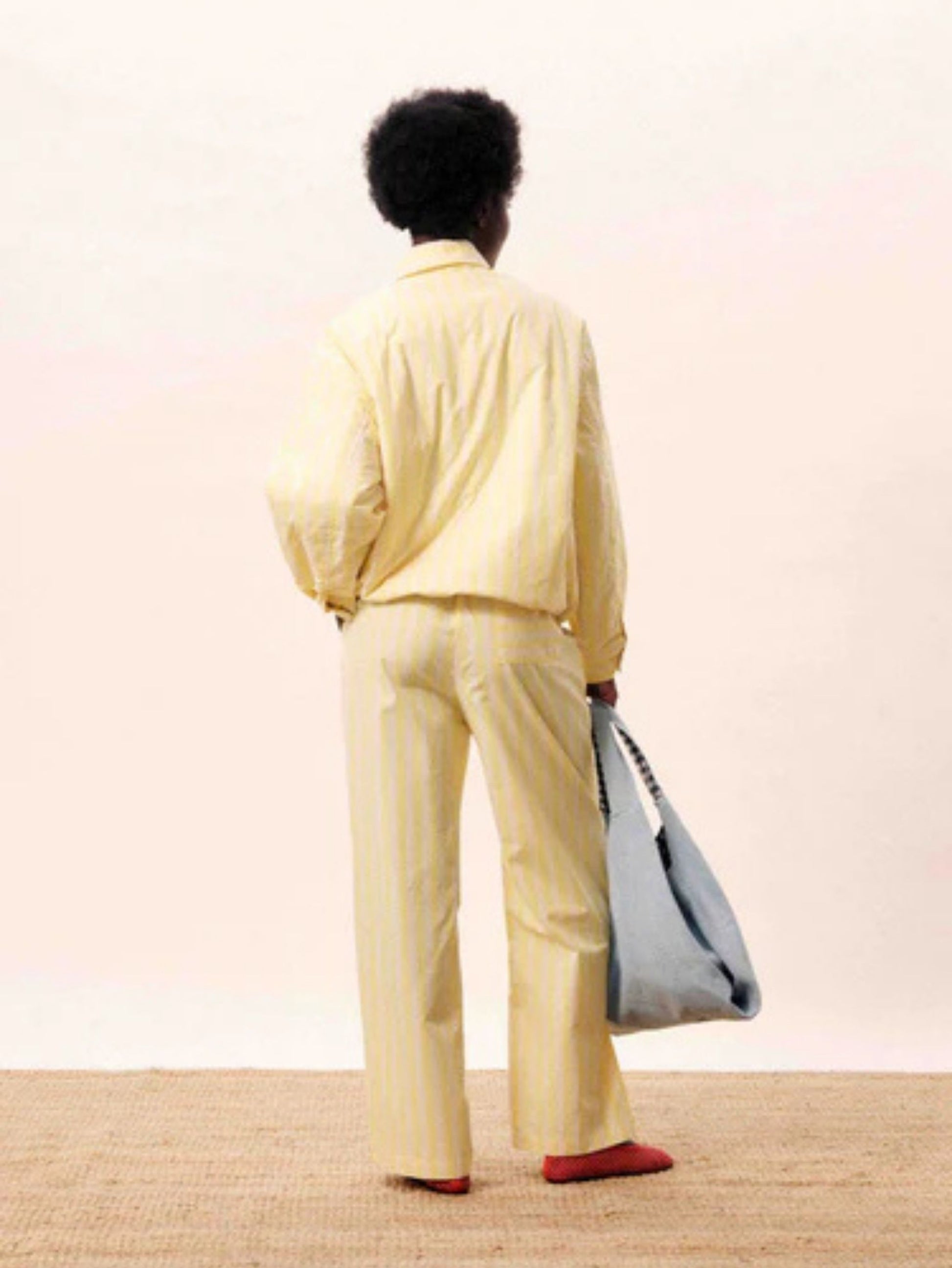 Butter yellow striped wide-leg trousers with a relaxed fit and lightweight tailored finish.
