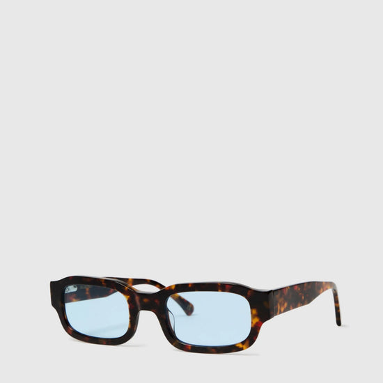 Sunglasses with tortoiseshell frame and blue lenses on a white background