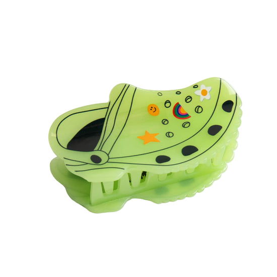 Green Croc inspired shaped hair clip on white background.