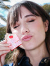 Woman holding a cake shaped hair clip 