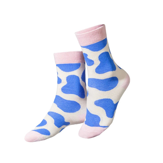 Pair of socks with blue cow print on a white background, featuring a 'Kids Club' logo.