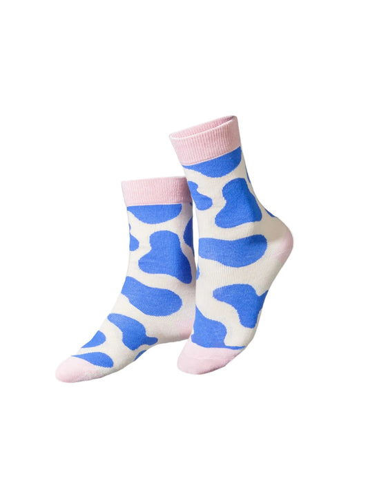 Pair of socks with blue cow print on a white background, featuring a 'Kids Club' logo.