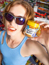 Person holding a jar of socks that look like peanut butter in a store setting