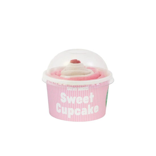 Pink cupcake-shaped container with a pair of pink and white socks inside on a white background