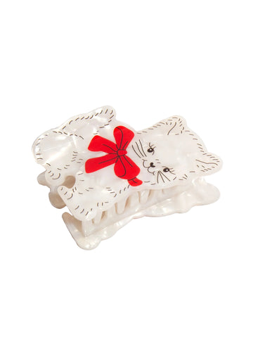 Cat-shaped hair clip with a red bow on a white background