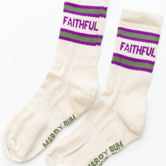 Pair of cream socks with purple and green striped bands and 'Faithful' text on a white background.