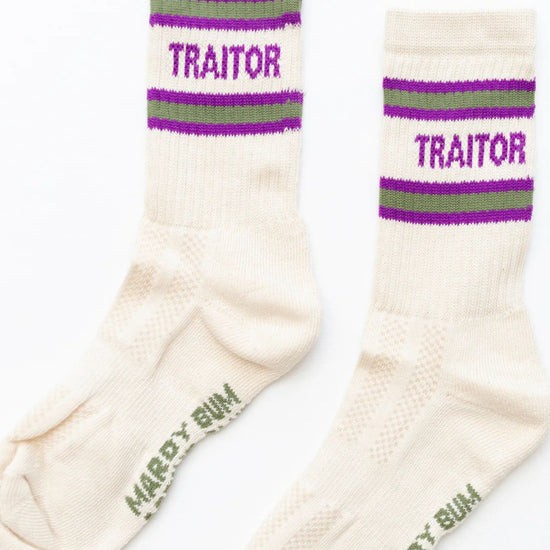 Pair of socks with 'Traitor' text and purple and green stripes on a white background