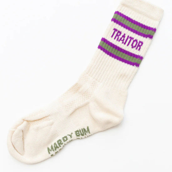 White sock with purple and green striped cuff and 'Traitor' text on a white background