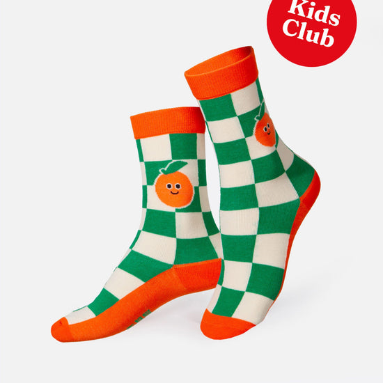 Pair of green and orange checkered socks with orange accents on a white background.