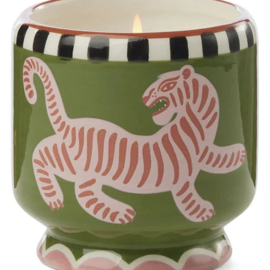 Paddywax black cedar and fig candle in a green container with a pink tiger design 