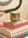 Paddywax black cedar and fig candle in a green container with a pink tiger design 