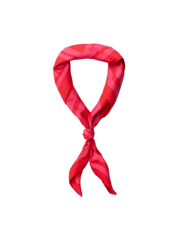 Red patterned scarf tied in a knot on a white background