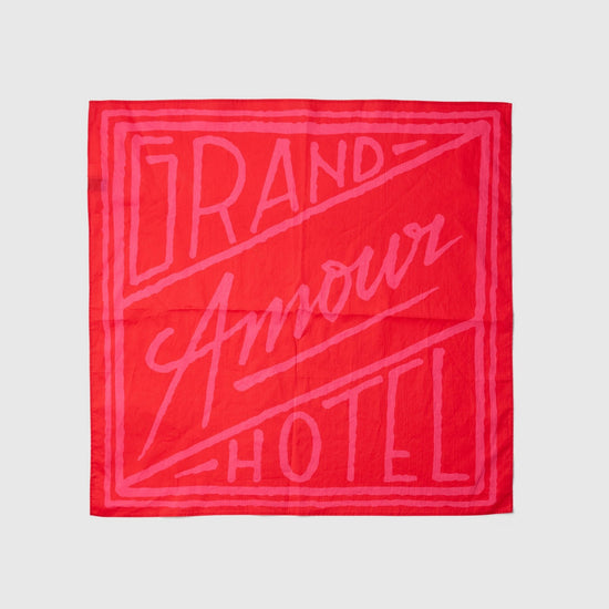 Red bandana with 'Grand Amour Hotel' text on a white background