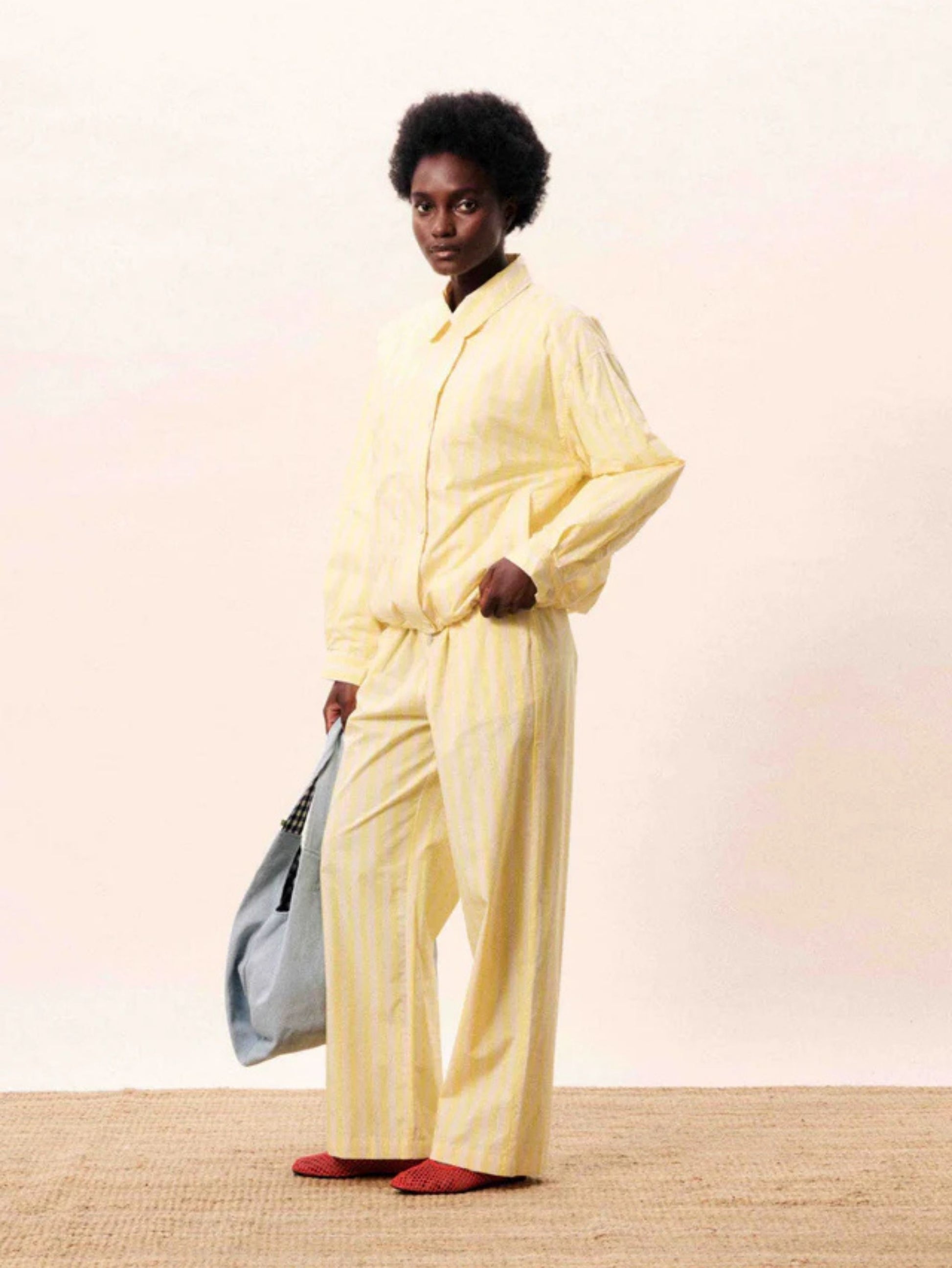 Butter yellow striped jacket with a relaxed fit, button and hidden zip front.