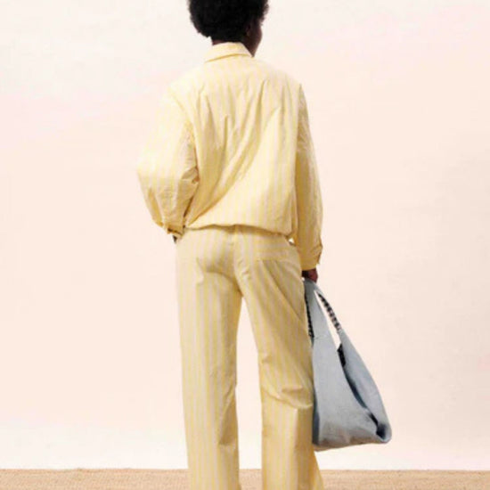 Butter yellow striped jacket with a relaxed fit, button and hidden zip front.