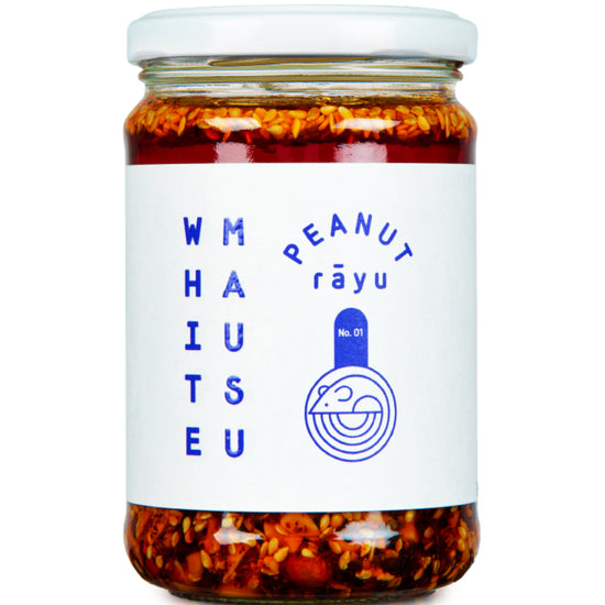 A glass jar of White Mausu Peanut Răyu chili oil with visible red chili peppers and seeds suspended in the reddish-brown oil, sealed with a white lid and featuring a white label with blue text and logo.